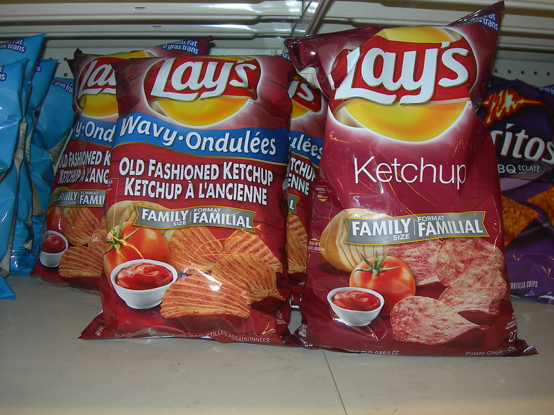 Close-up Photo of Ketchup Potato Chips placed on a market rack