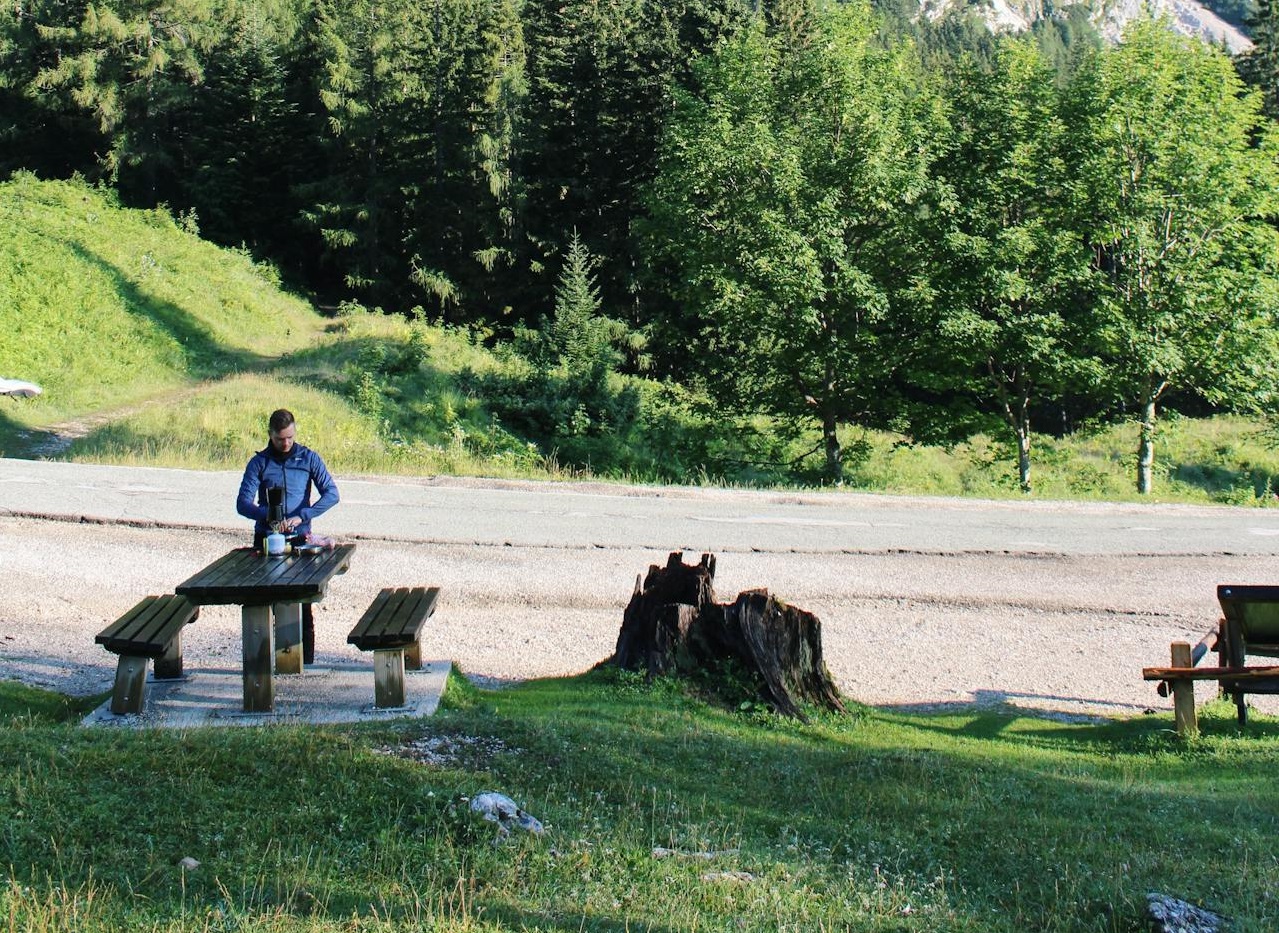 Man Standing on Wooden Table with Benches