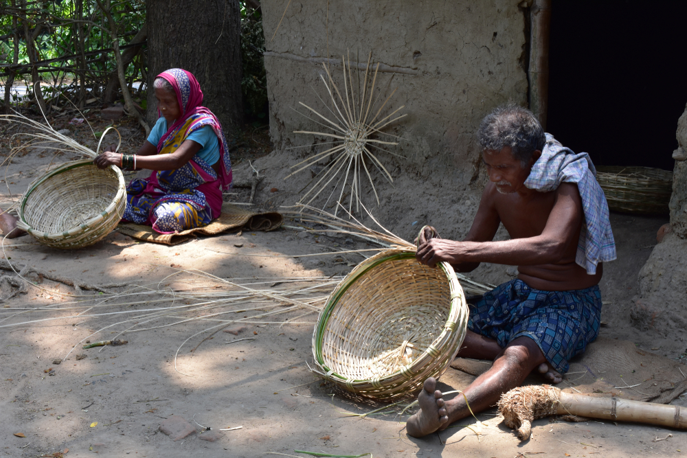 Indian couple weaving basket