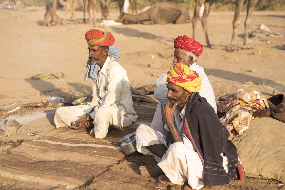 Men by a fire pit in India