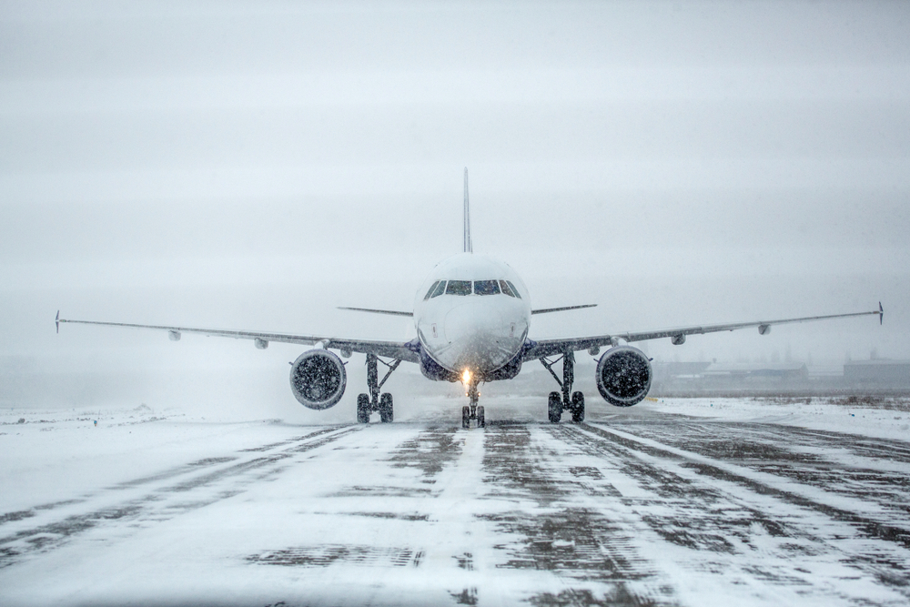 Passenger plane in snow at airport