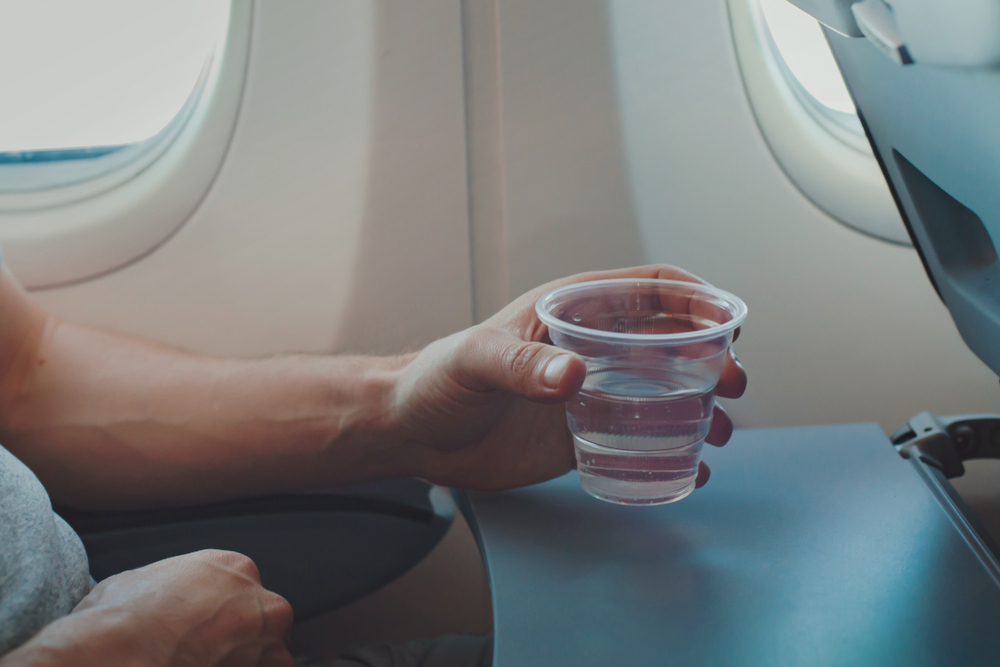 Passenger drinking water in airplane