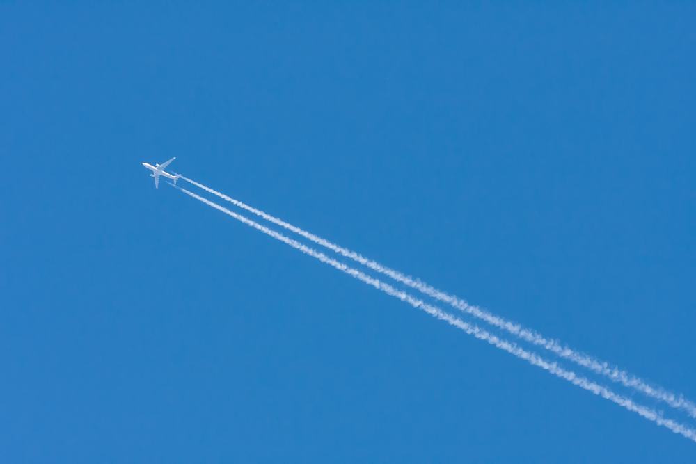 Large airliner in the blue sky without clouds