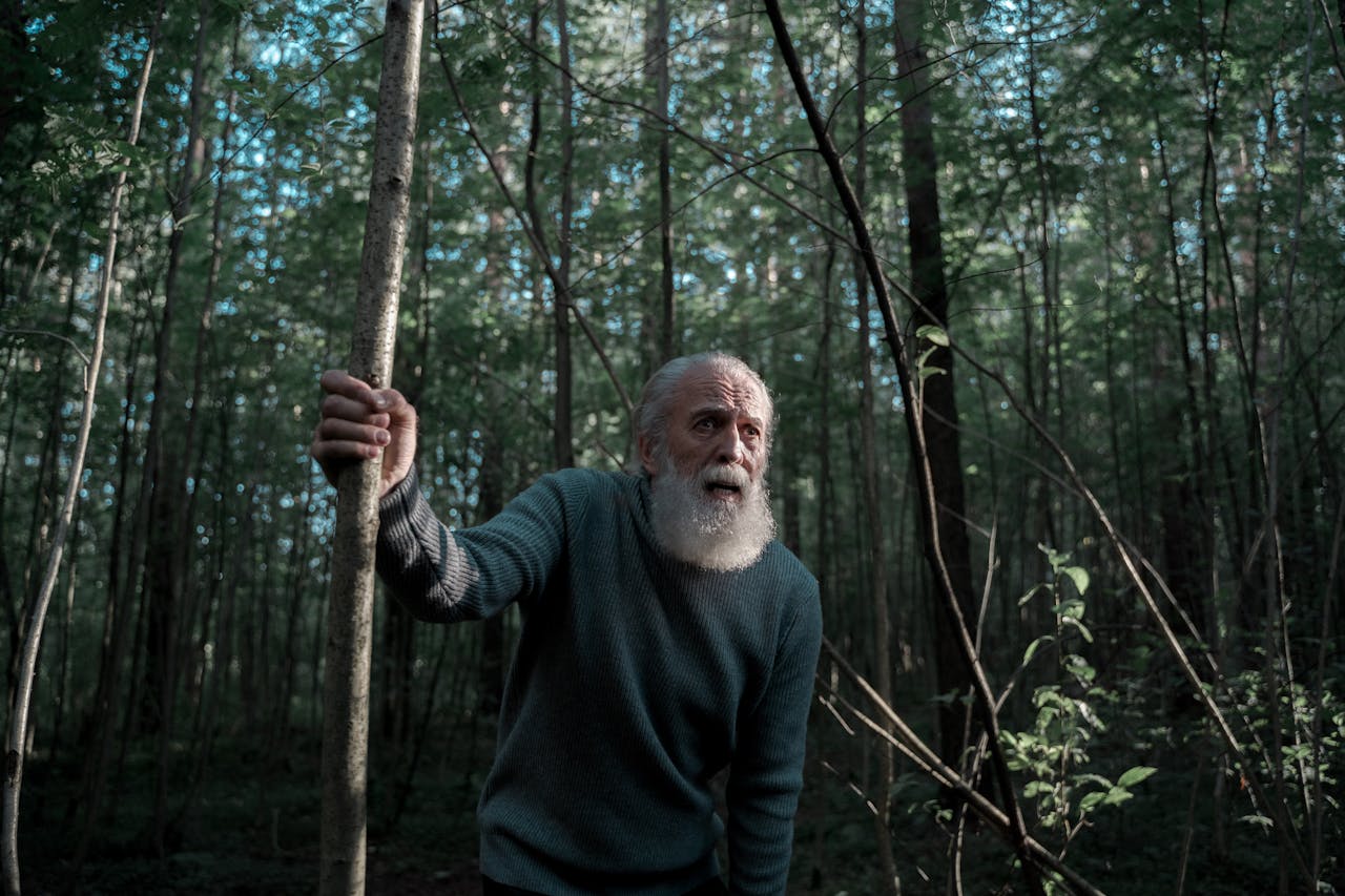 Scared senior man in the woods.