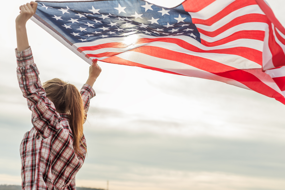 young beautiful woman holding USA flag