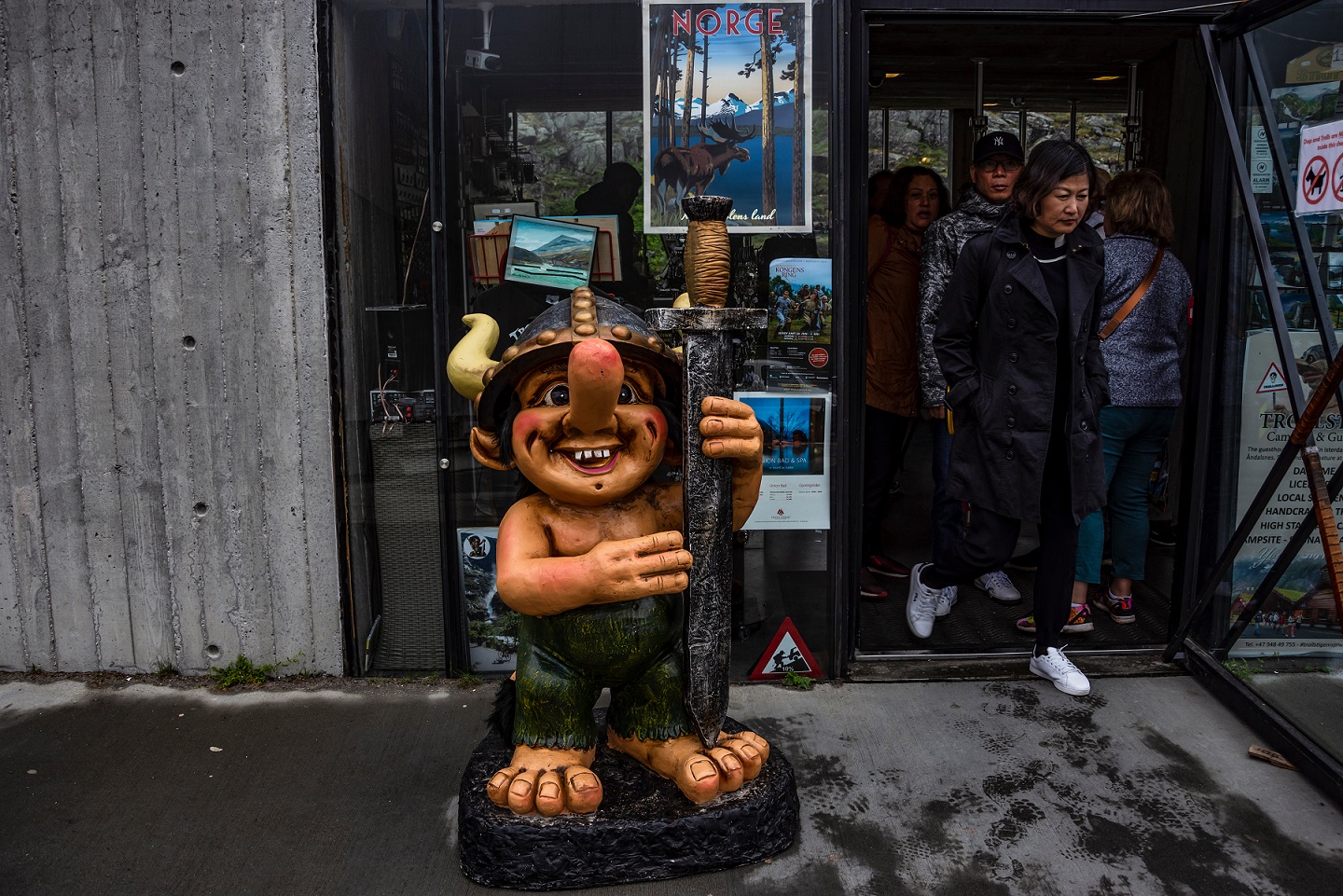 Troll mascot in front of a store building on the Trollstigen mountain road - 2018