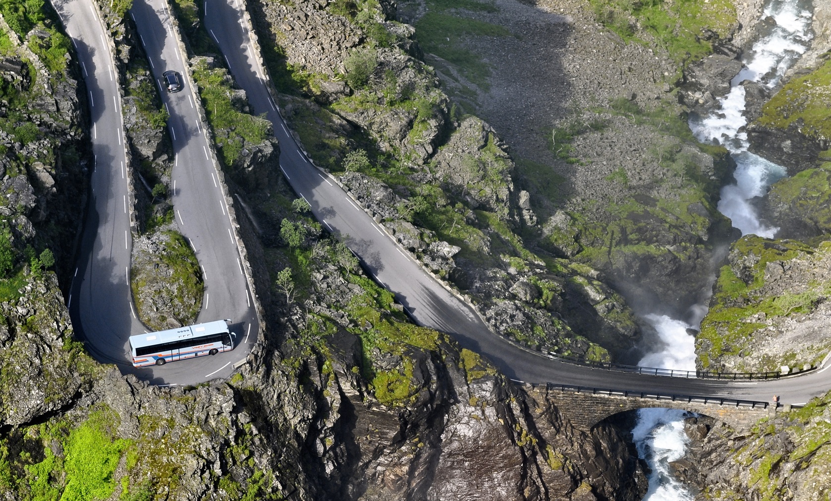 A bus with tourists one at a bend on a troll road in Norway. - 2011