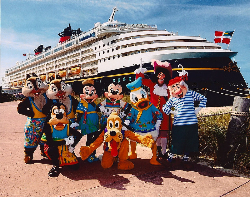 All of the Disney characters in front of the Disney Magic Ship