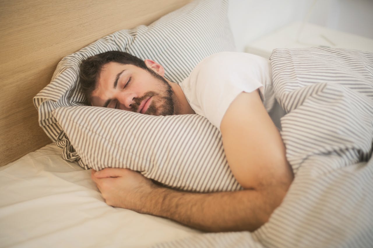 Man sleeping while hugging a pillow
