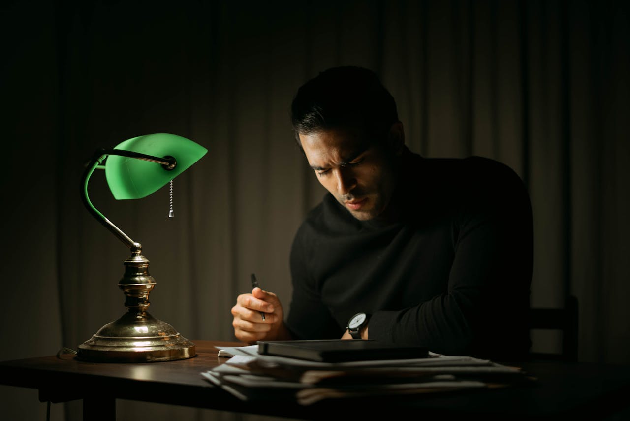 man doing paperwork in late hours
