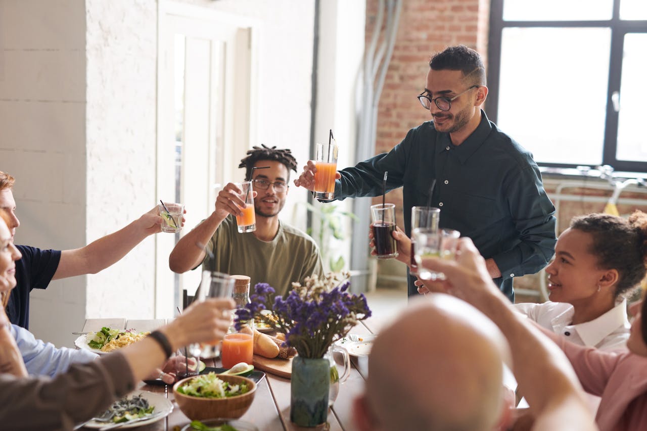 People cheering and having dinner