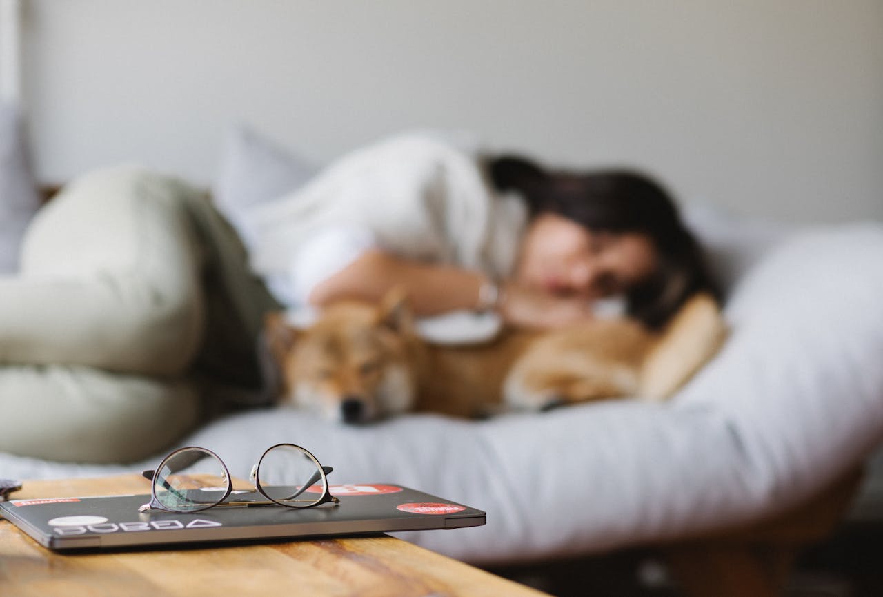 Women sleeping on the bed with her dog