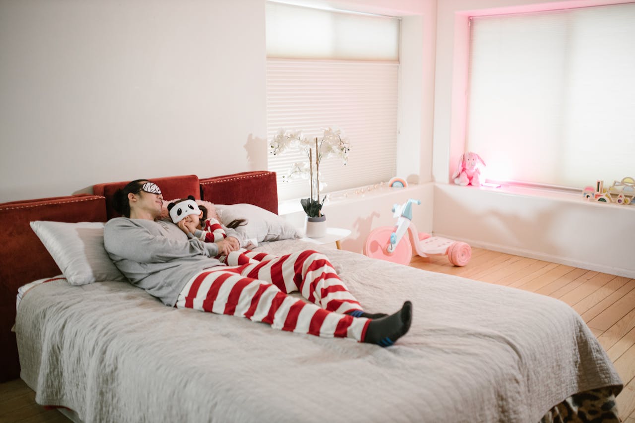 Father and Daughter sleeping together in red pajamas