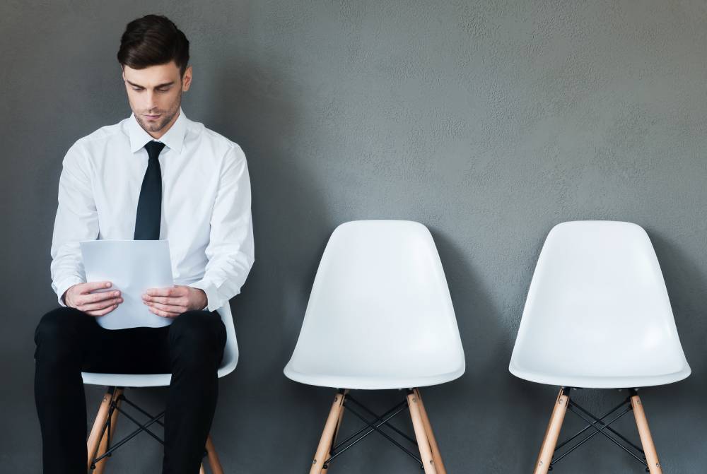 Man sitting on white chair and waiting