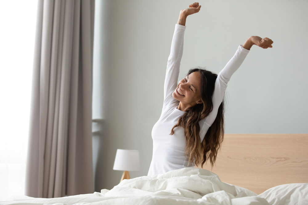 girl in white pajamas doing morning scratch