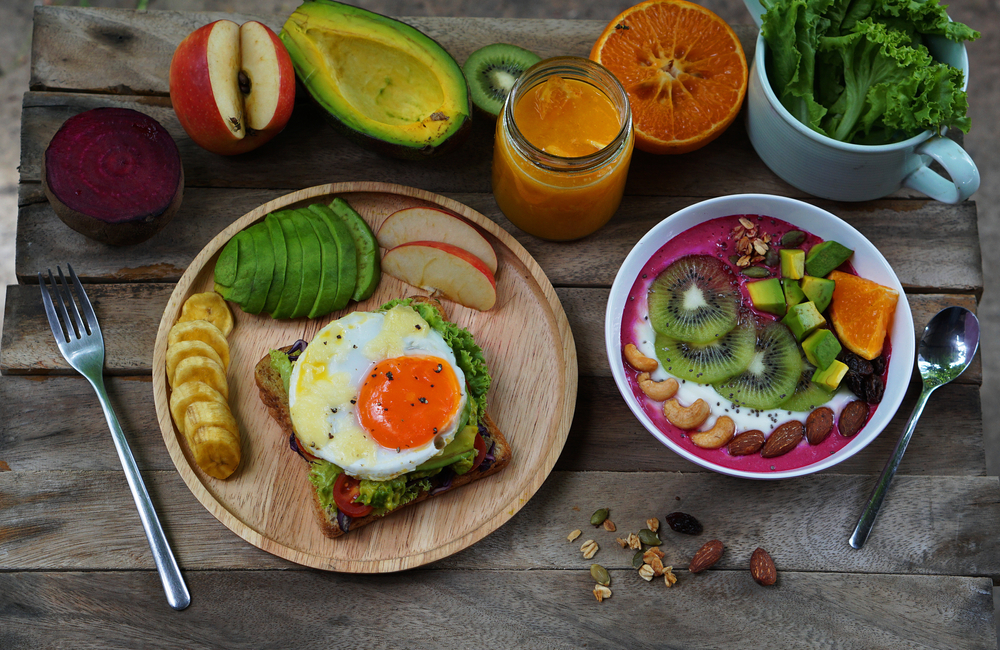 Sandwich with avocado with egg and fruit yougurt