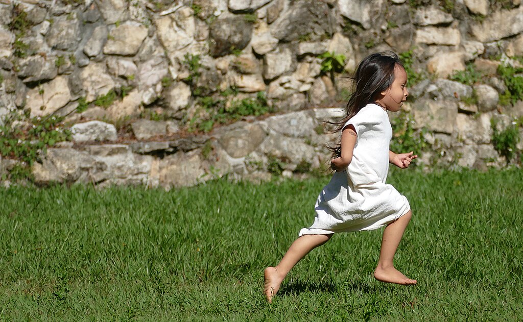 Lacandon Little Girl Running In The Grass At Bonampak
