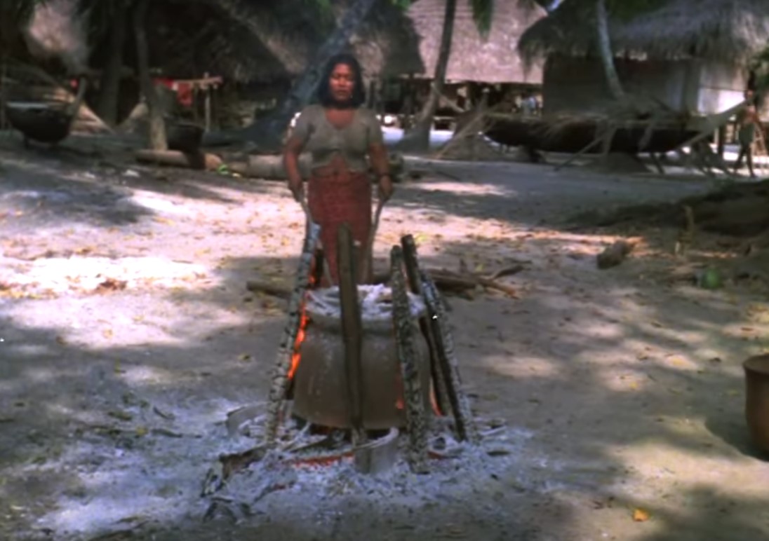 Onge woman making food on the fire