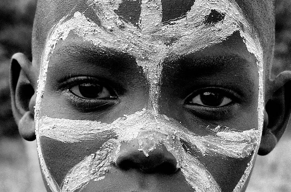 tribe boy with white paint on his face