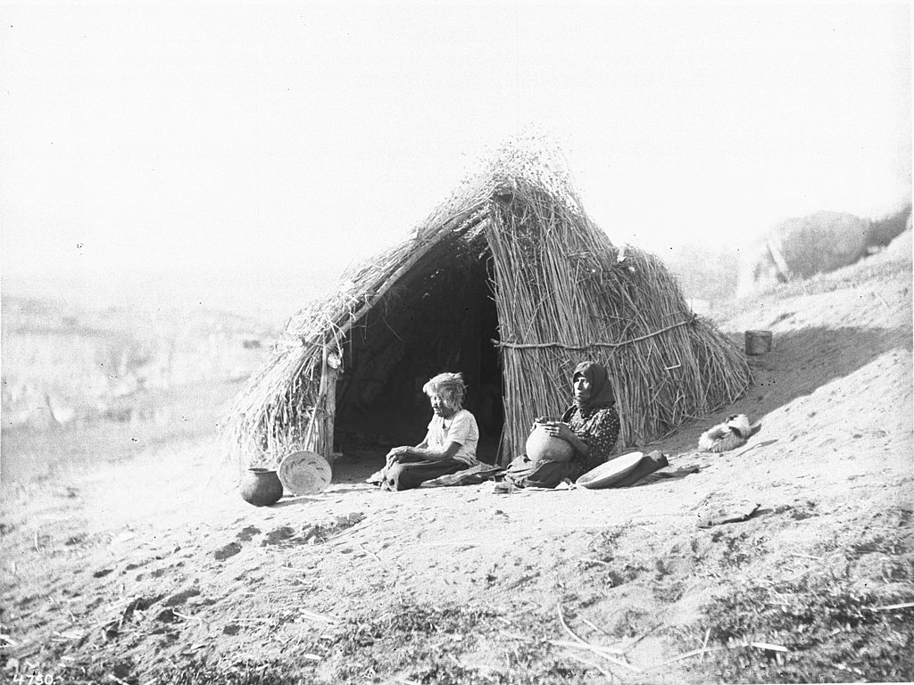Photograph of two Coahuilla Indian women in front of their "kish"
