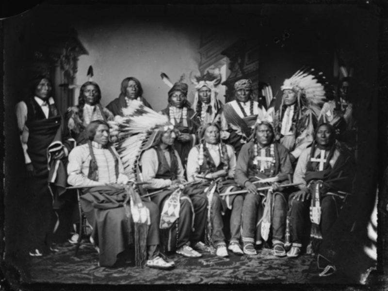 A black and white photo of a group of Indian people.