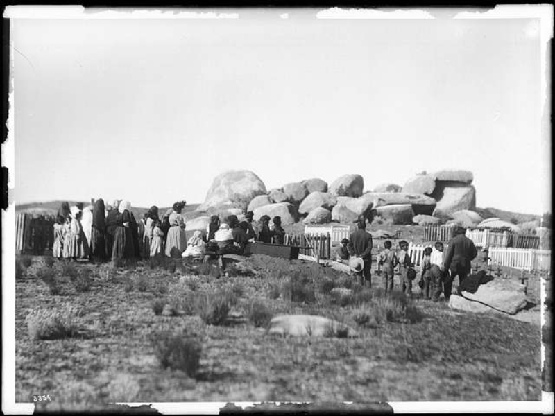 Photograph of a Coahuilla people standing in front of big stones