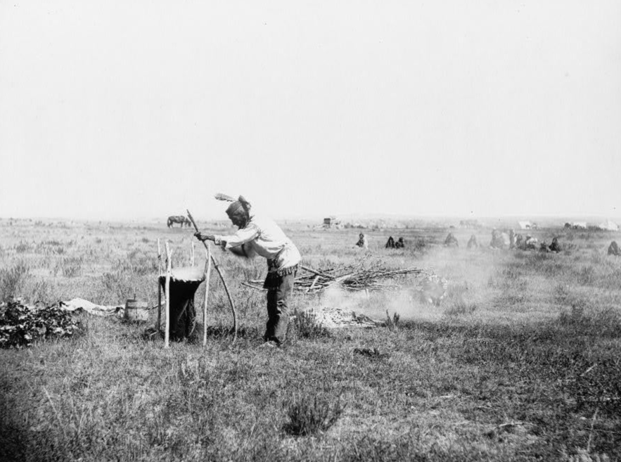indian man cooking on the fire