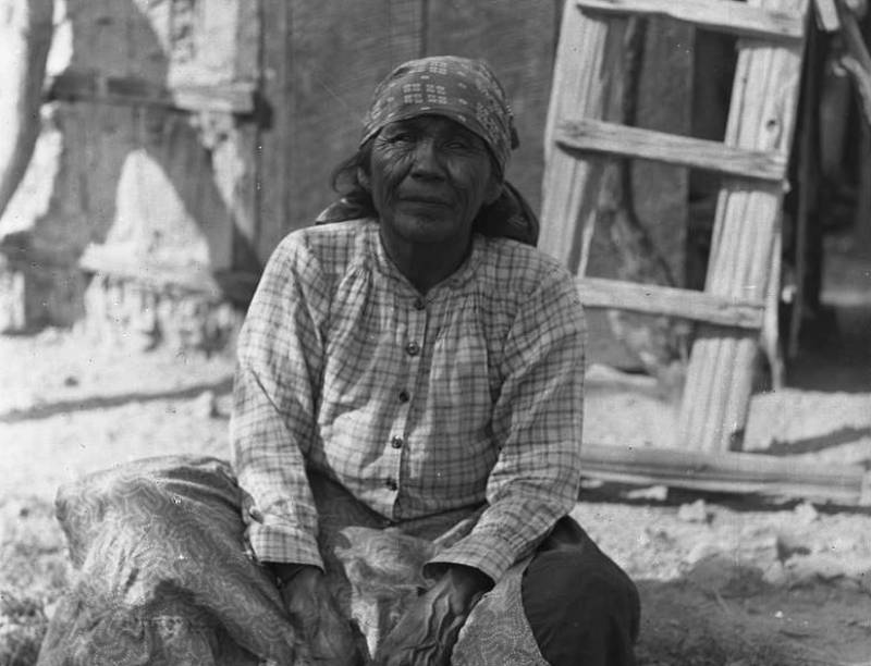 Photograph of a Cahuilla Indian woman sitting crosslegged