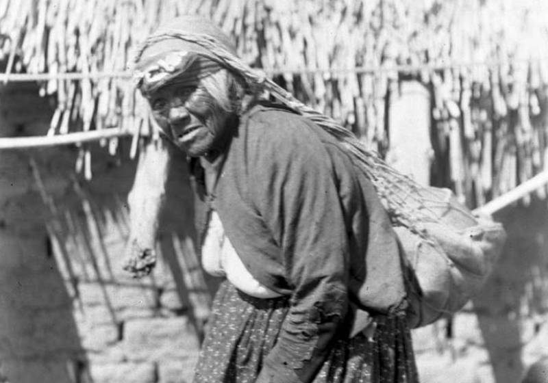 Coahuilla Indian woman carrying net suspended from her head