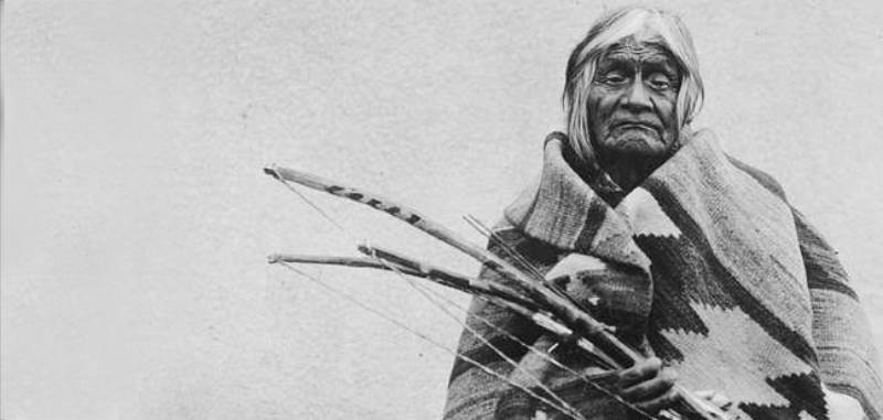 Indian man holding bows in his hands
