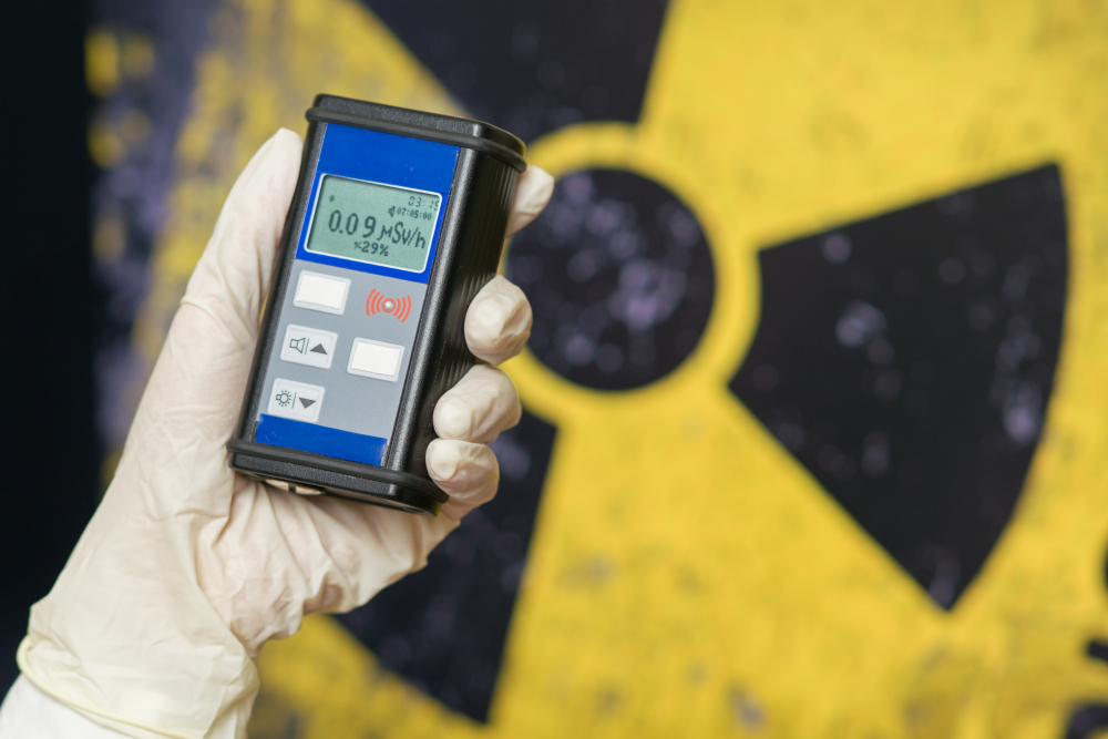 Radiation supervisor in glove with geiger counter