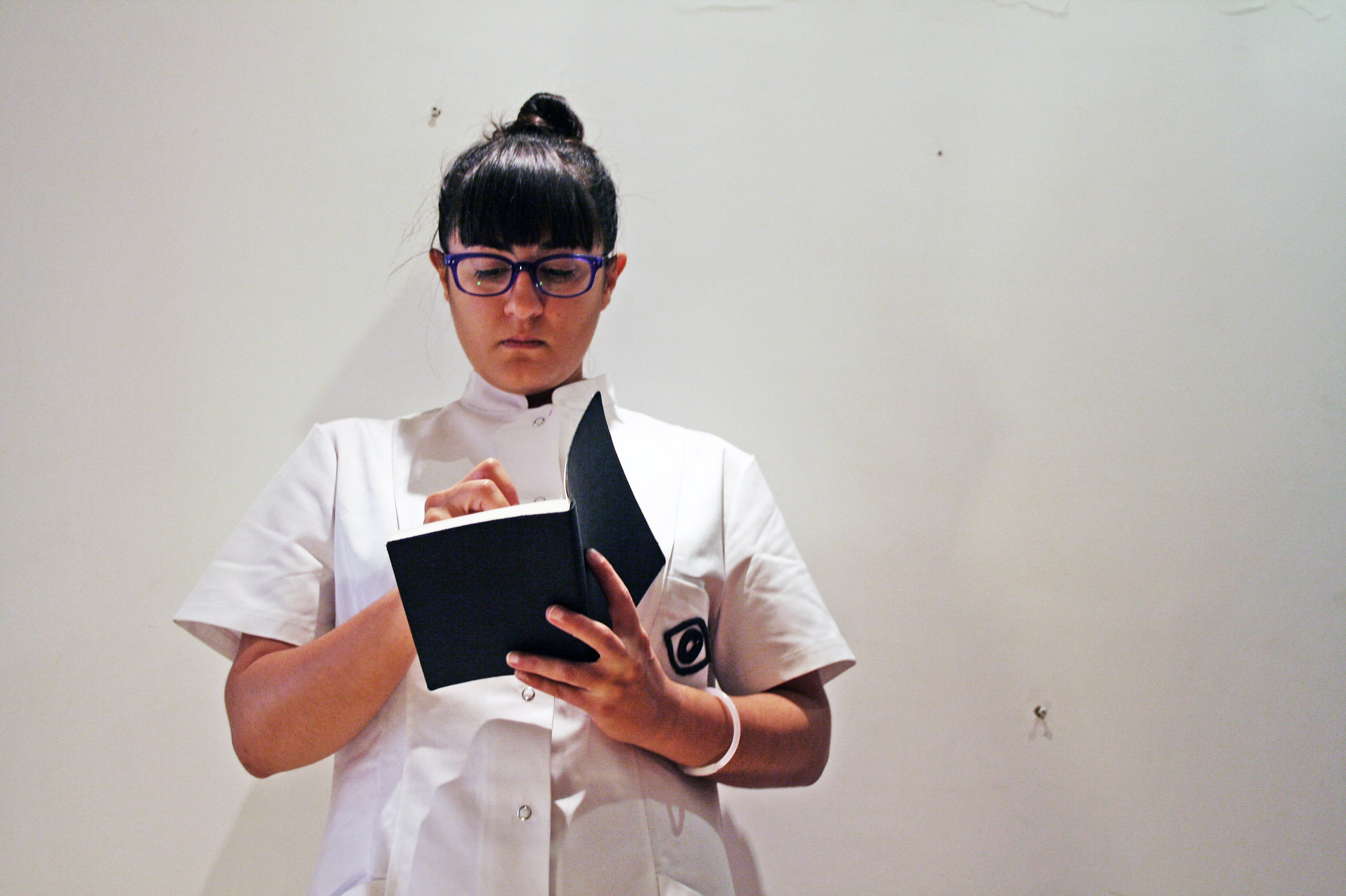 A nurse holding a notebook in her hands.