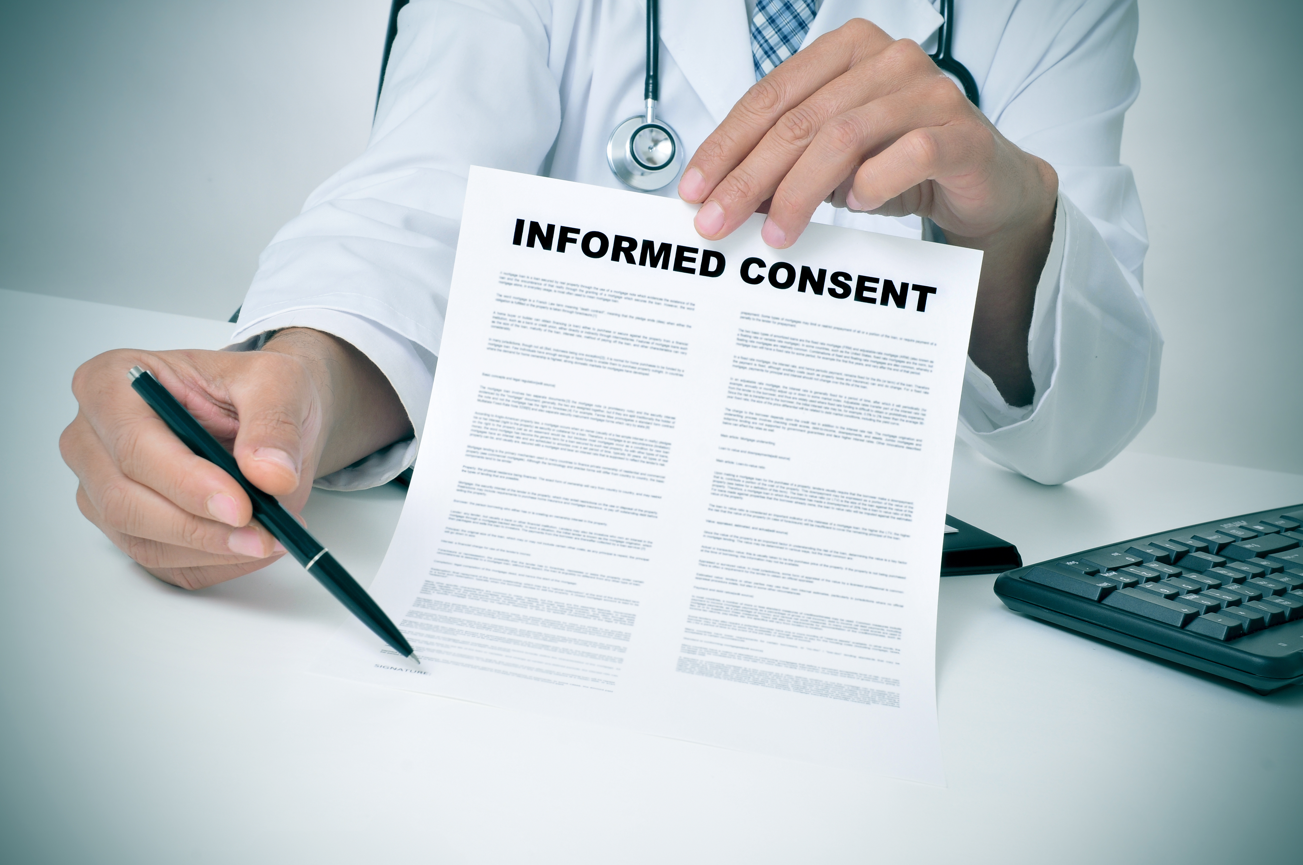A doctor in his office showing an informed consent document