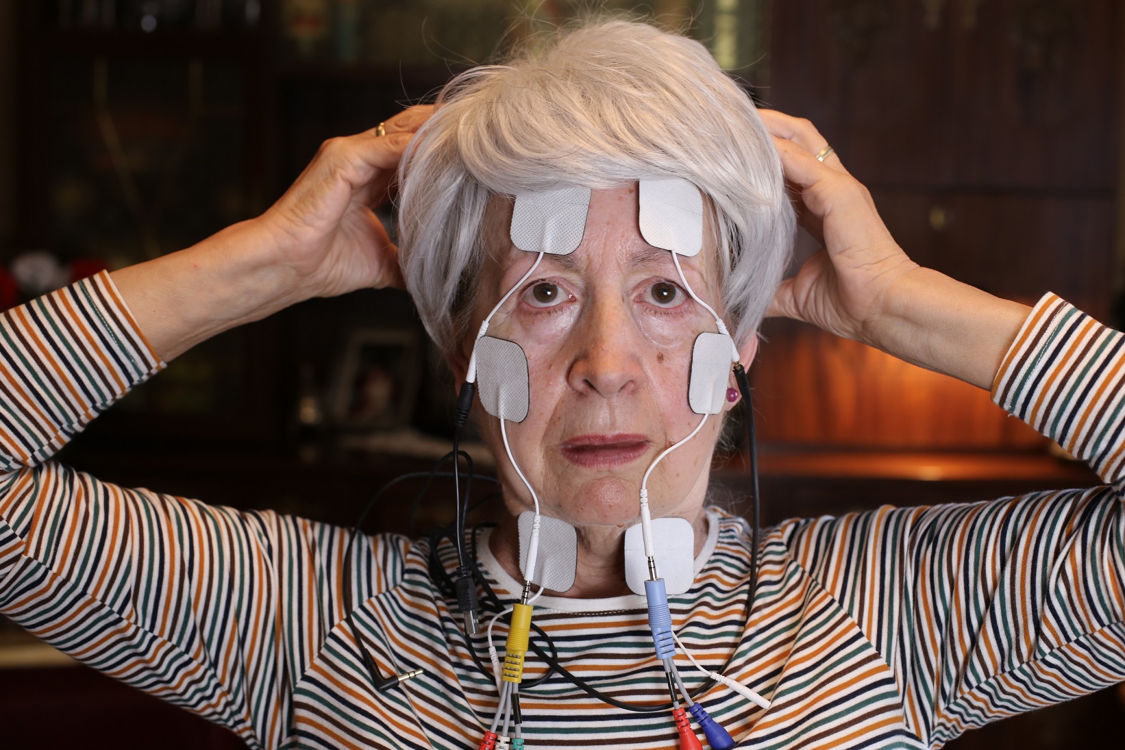 Lady trying alternative therapy with electro stimulation