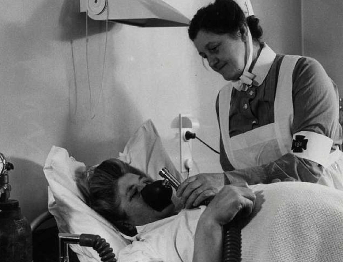 Woman in hospital bed.