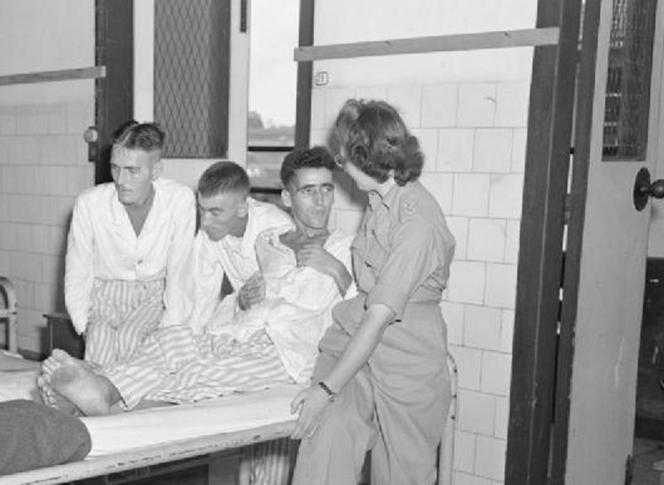 Two army nurses talk to former prisoners of war