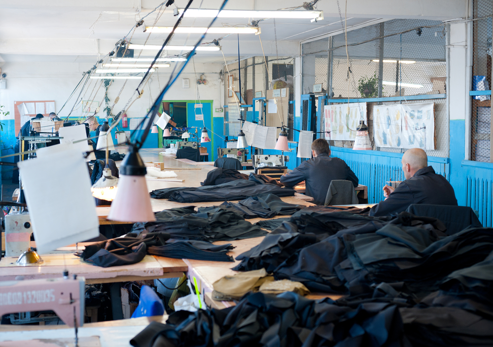 men prisoners sew uniforms at a sewing workshop