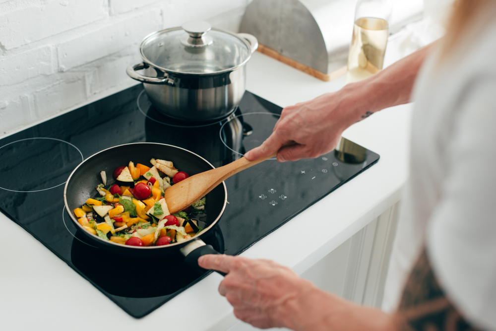 cropped shot of man cooking vegetables