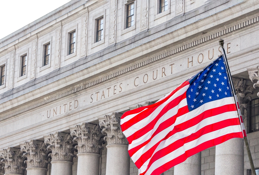 USA national flag waving in the wind in front of United States Court House