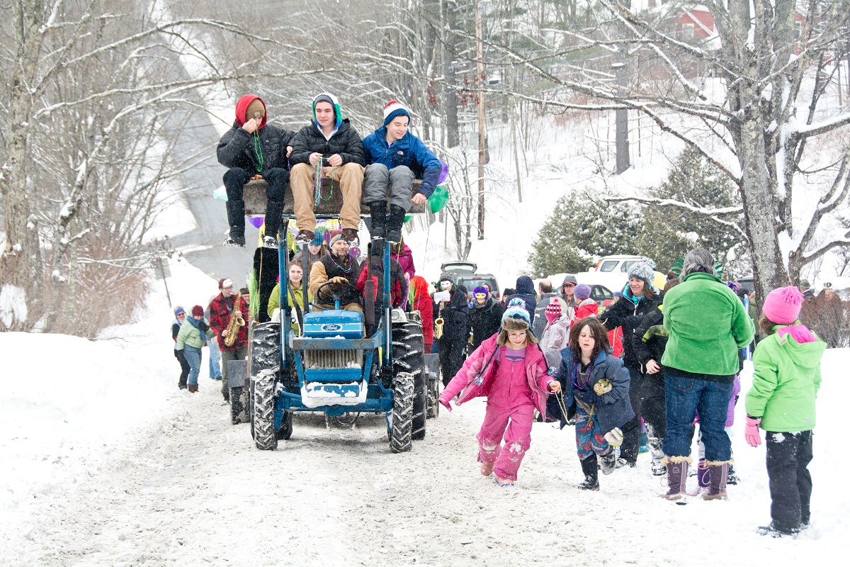 Children run alongside the community Mardi Gras parade in the village of Maple Corner, Vermont - 2014