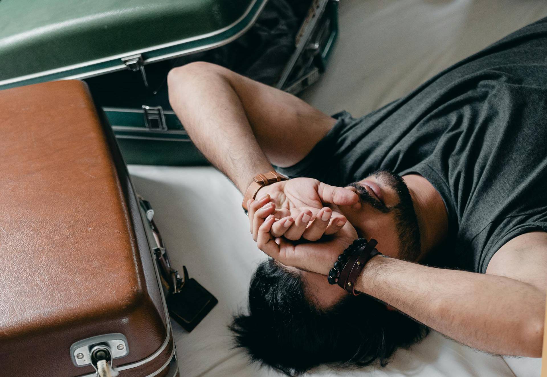 Man lying in bed in a hotel room