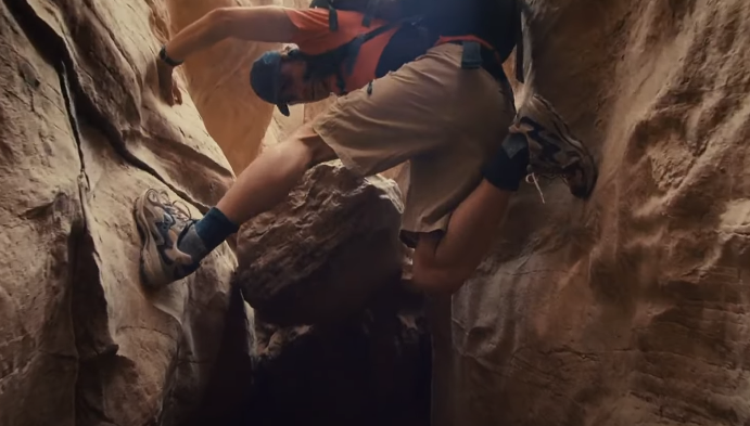 man climbing on a cliff