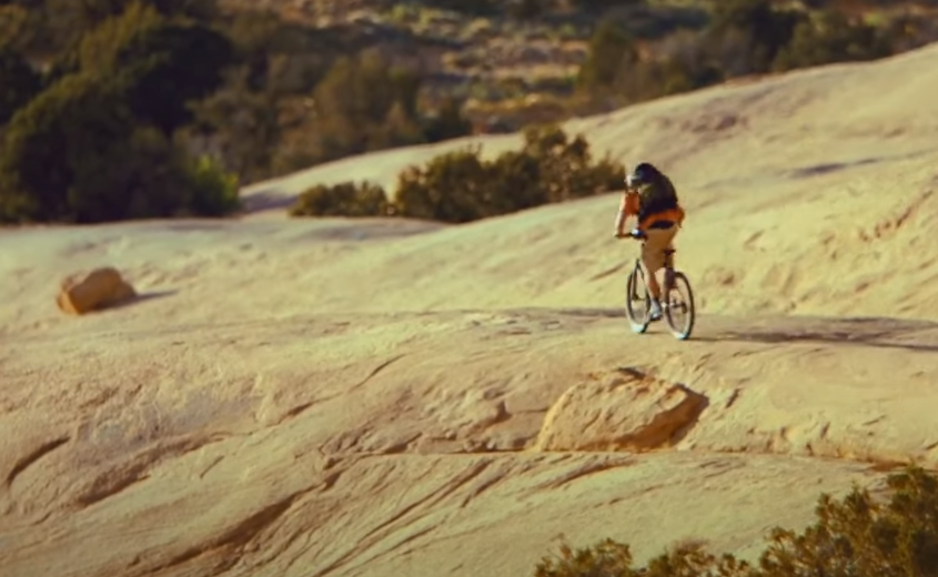 image of person cycling in the mountains
