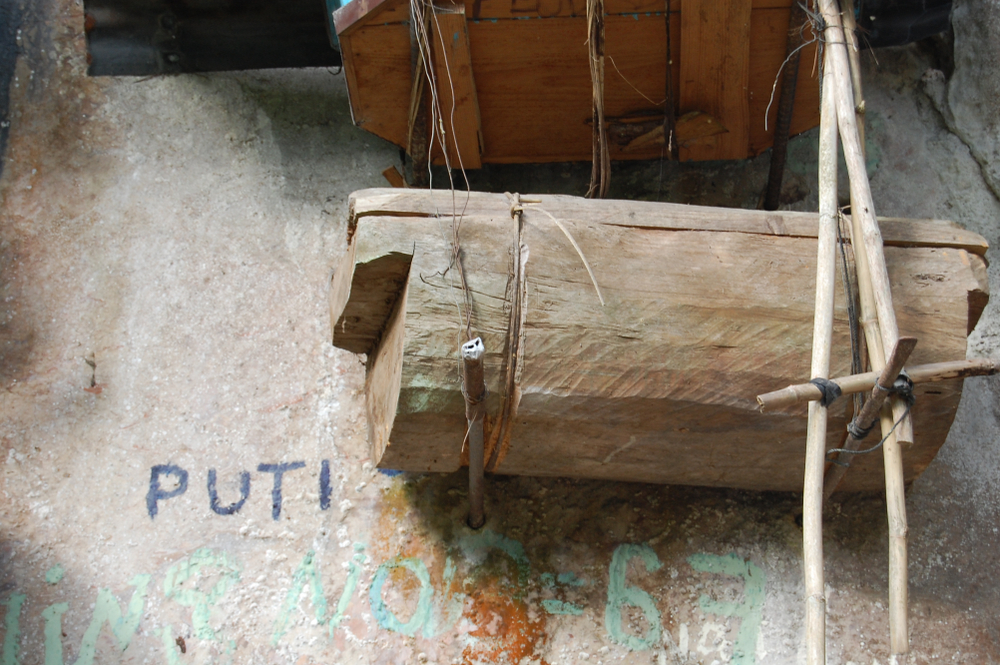 small coffin hanging on a rock