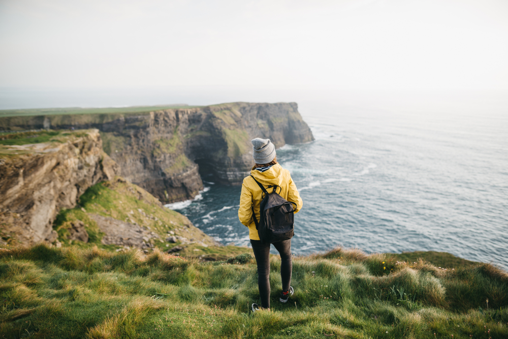 girl standing on the Cliffs of Moher