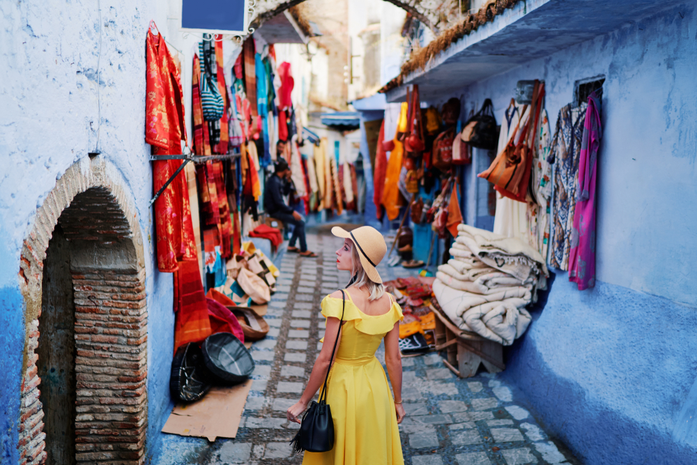 Young woman in yellow dress tourist sightseeing