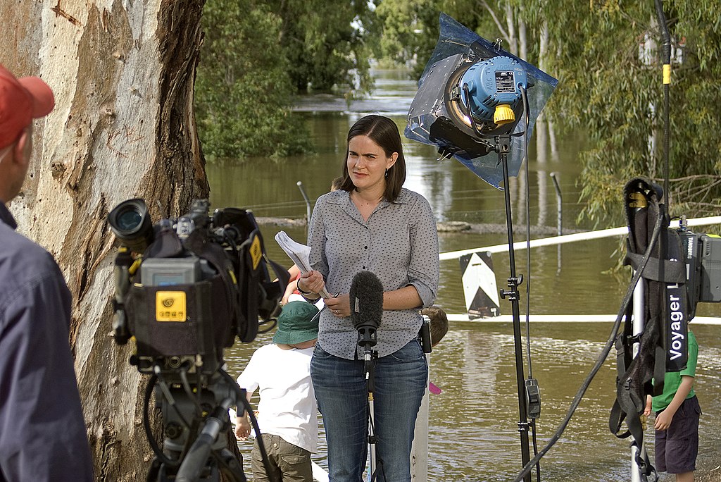 ABC News reporter, Naomi Woodley, waiting to do a live report