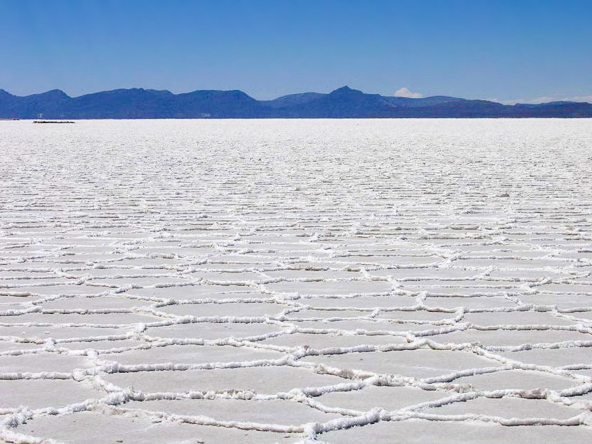 Landscape Photo of Salar de Uyuni with mountains and clear sky in the background