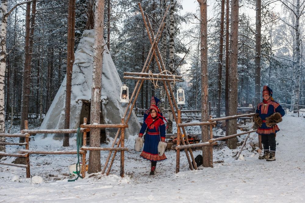 Two Sami people near their “lavvu” house