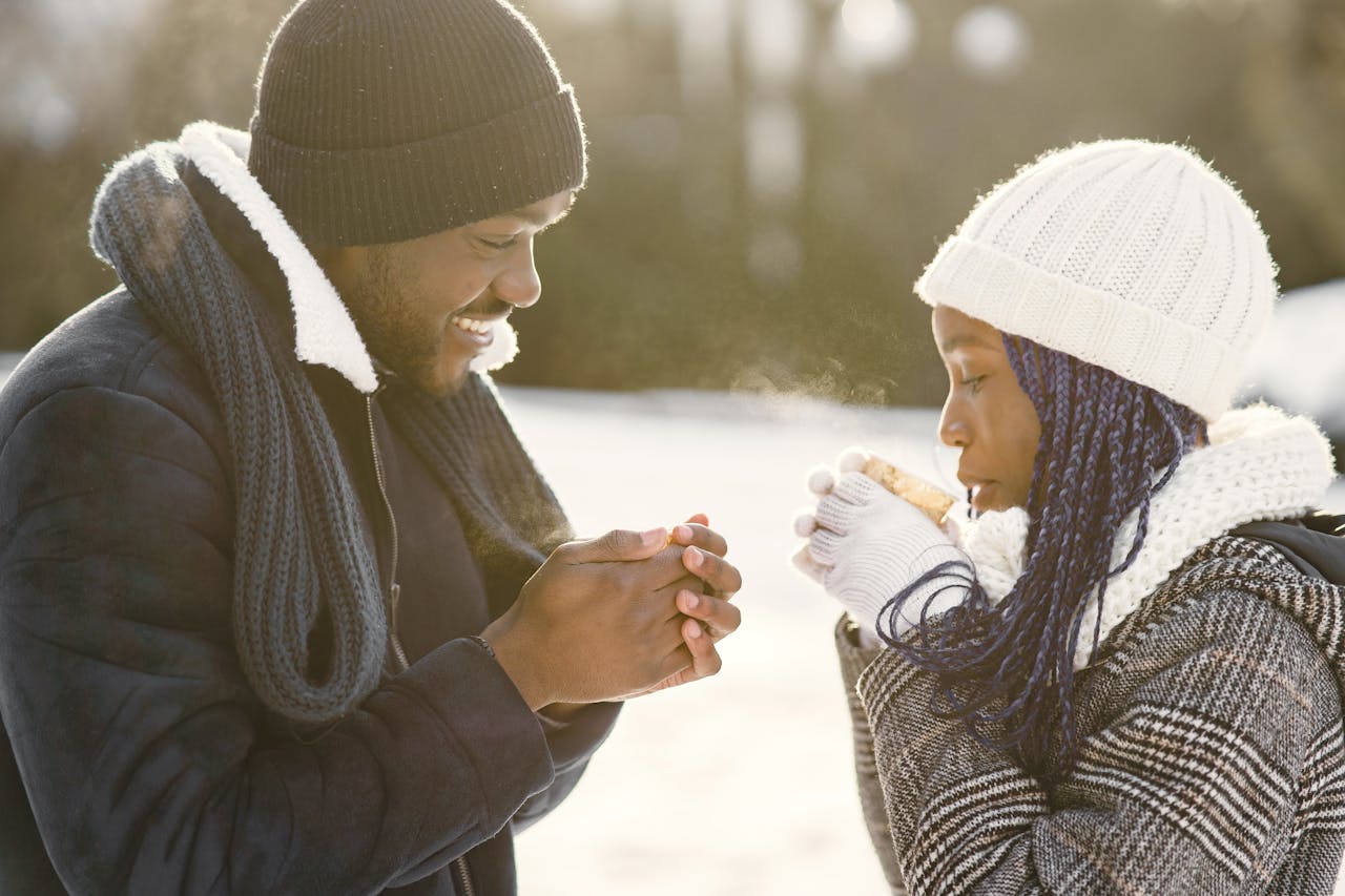 couple drinking hot cocoa outside.
